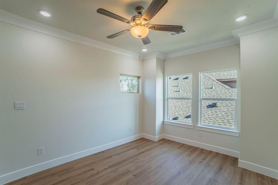 Spare room with ornamental molding, light wood finished floors, a ceiling fan, and recessed lighting Spare room with ornamental molding, light wood finished floors, a ceiling fan, and recessed lighting