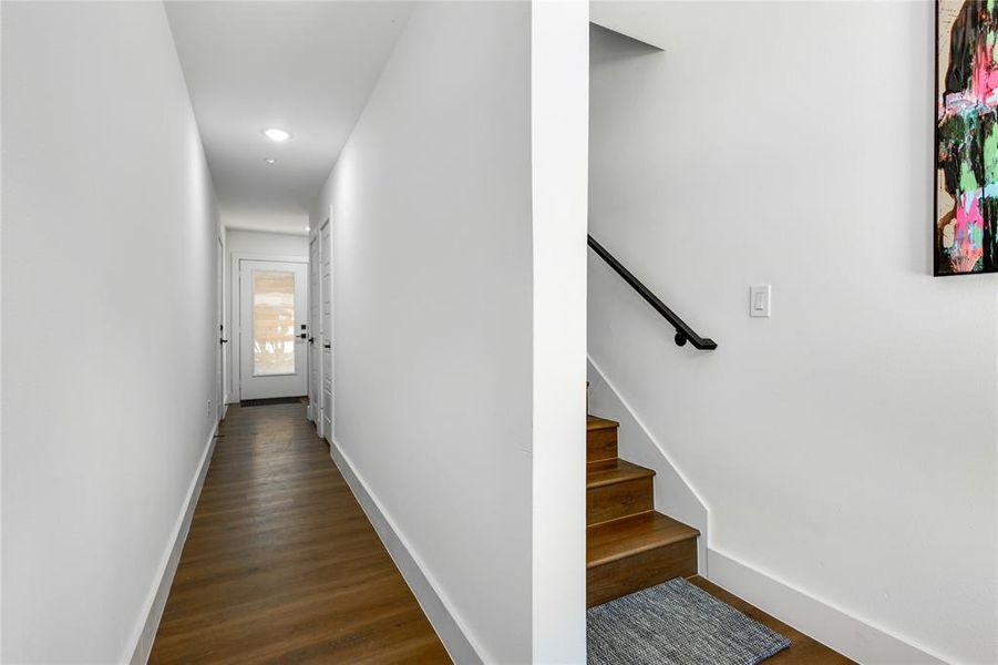 Hallway with dark hardwood / wood-style floors