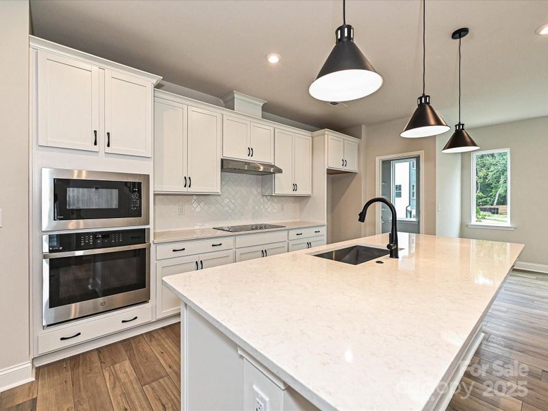 Quartz Countertops and Striking White Cabinetry.