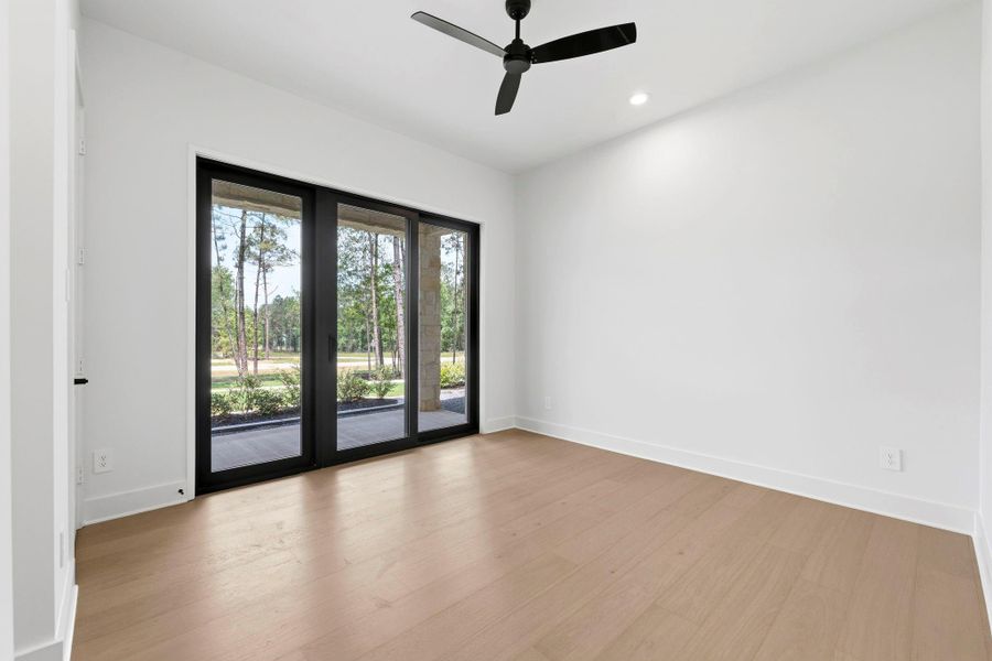 Bedroom #2. Located downstairs and has SLIDING glass doors that lead you to the front porch/ patio. Has it's own en-suite full bath!
