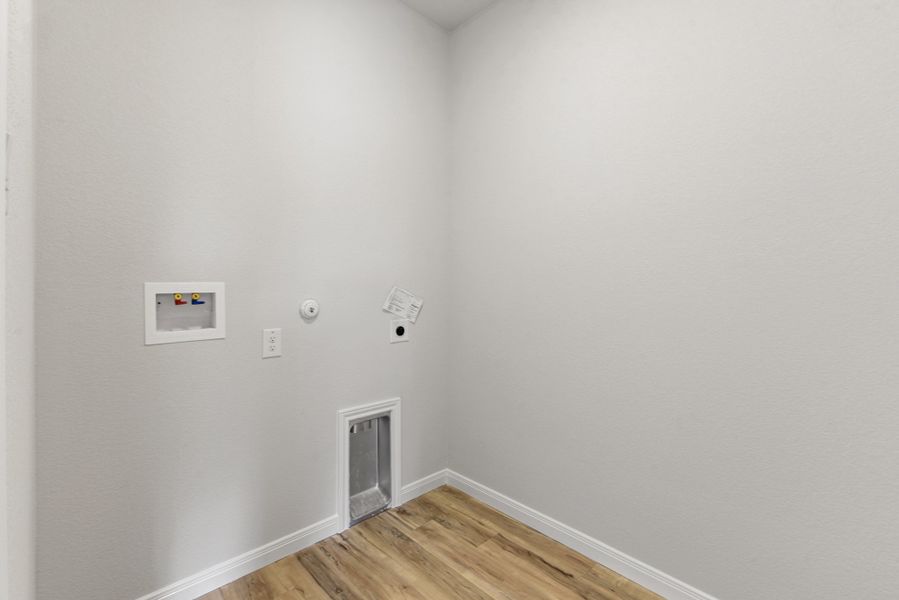 A room with a wood floor and white walls.