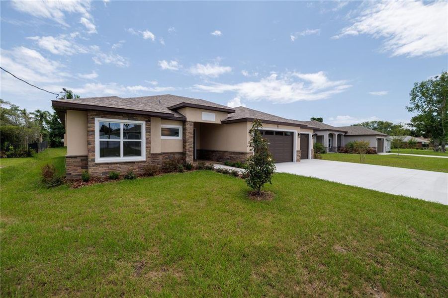 Front exterior of a new home in , Palm Coast, FL, highlighting curb appeal (Image 1). Front exterior of a new home in , Palm Coast, FL, highlighting curb appeal (Image 1).