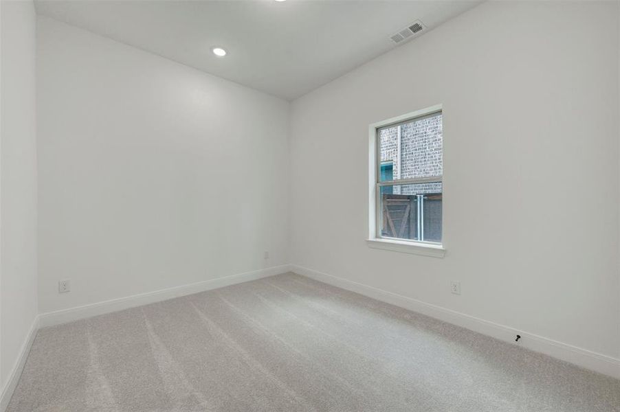 Room featuring light gray carpet, white painted walls, a single window, recessed lighting, and white baseboards Room featuring light gray carpet, white painted walls, a single window, recessed lighting, and white baseboards