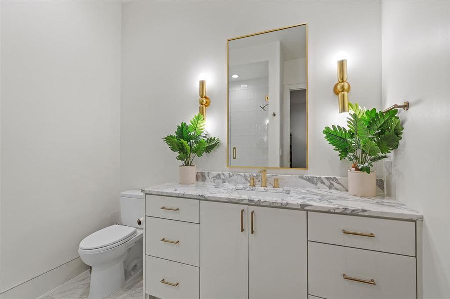 Bathroom with vanity, a shower stall, and light marble finish flooring Bathroom with vanity, a shower stall, and light marble finish flooring