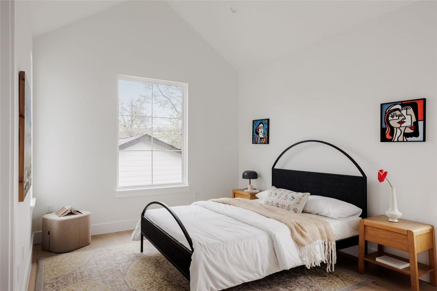 Bedroom featuring wood finished floors and baseboards