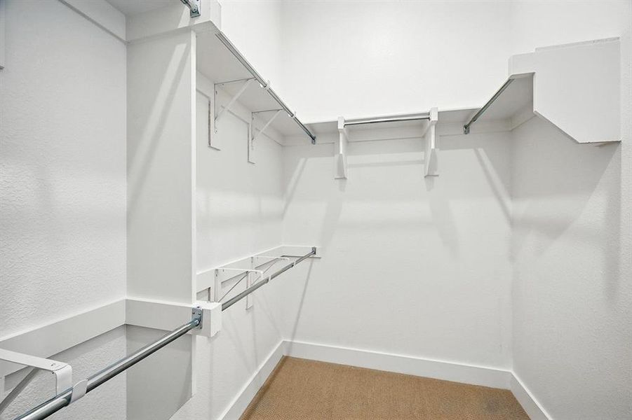 Spacious closet with light carpet Spacious closet with light carpet