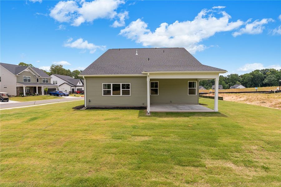A well-maintained lawn extends from this newly con