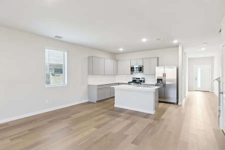 Kitchen and Dining Room in the Haylee home plan by Trophy Signature Homes - REPRESENTATIVE PHOTO