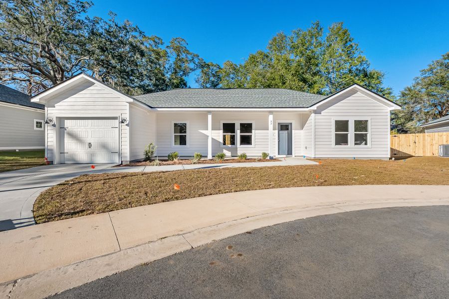 Front exterior of a new home in Live Oak Cottages, Freeport, FL, highlighting curb appeal (Image 1). Front exterior of a new home in Live Oak Cottages, Freeport, FL, highlighting curb appeal (Image 1).