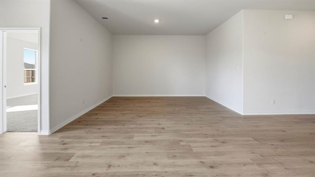 Empty room featuring light wood finished floors and baseboards