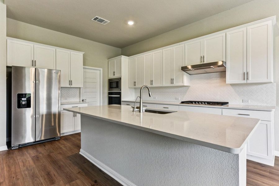 Grand eat up island & Sleek white cabinets w/ chrome hardware