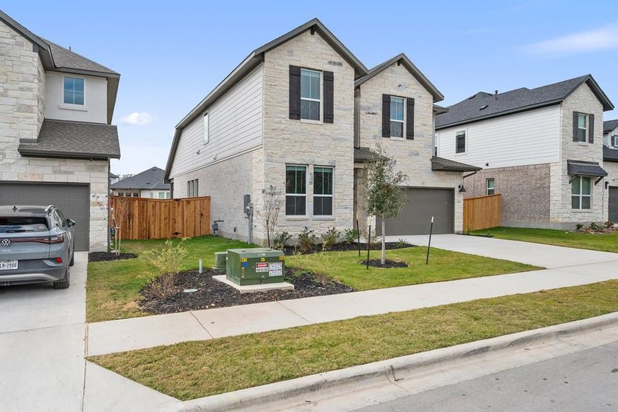 Front exterior of a new home in Arbor Collection at Heritage, Dripping Springs, TX, highlighting curb appeal (Image 24).