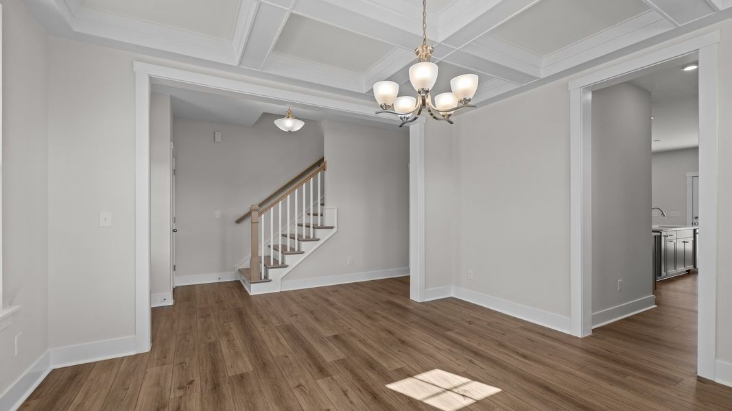 Burton design sun-lit dining room with raised tray ceiling and premium finishes. Lakeside Glen by DRB Homes, York, SC.