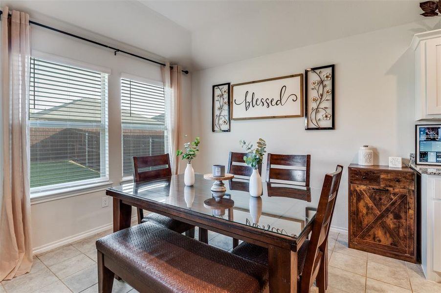 Dining space with light tile patterned flooring.
