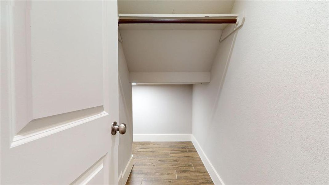 Large storage closet wraps around and under the stairway.