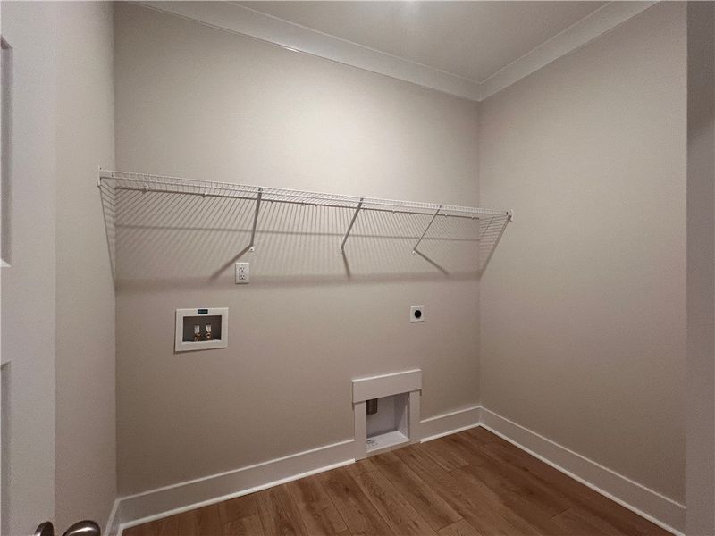 Large laundry room with a wire shelf for additiona