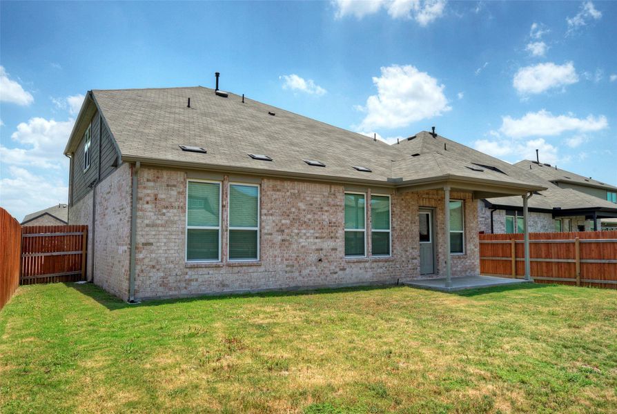 A well-maintained lawn provides a spacious private yard, fully enclosed by a robust wood fence. A well-maintained lawn provides a spacious private yard, fully enclosed by a robust wood fence.
