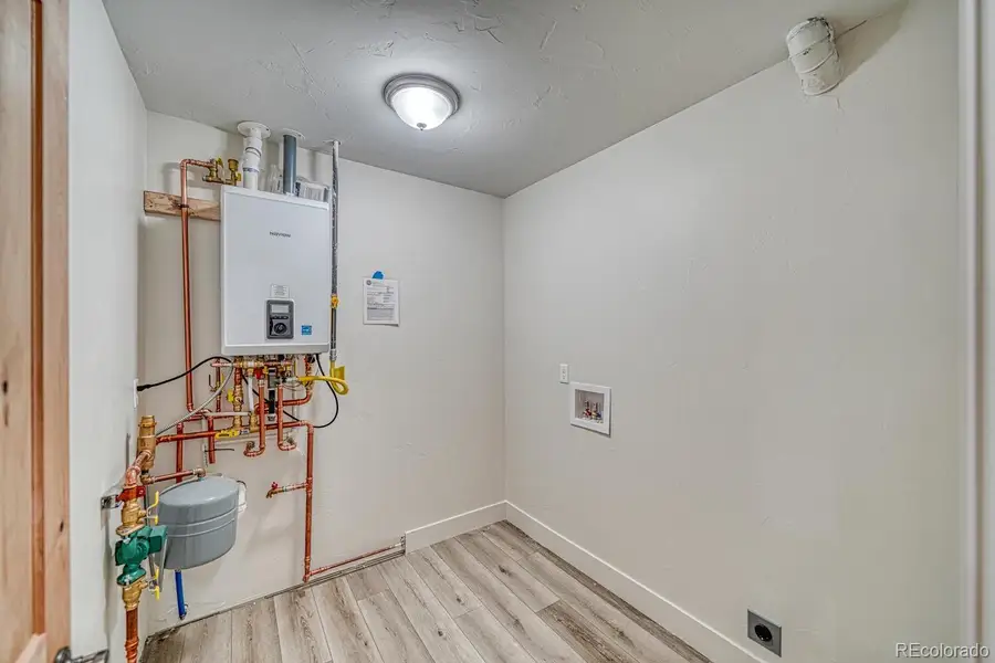 Laundry room with tankless water heater: Photos not of actual home but similar model Laundry room with tankless water heater: Photos not of actual home but similar model