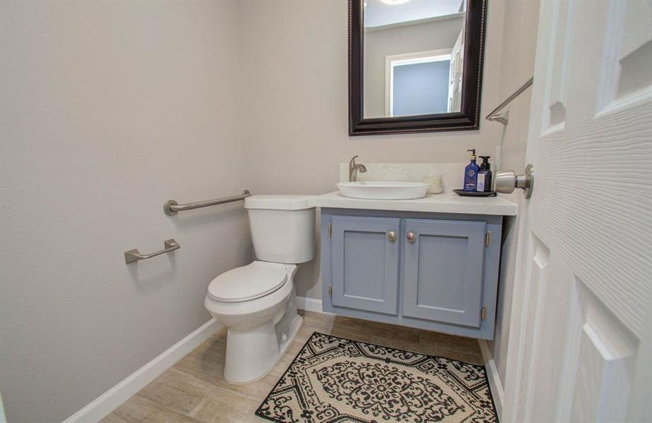 Home includes a powder half bath with upgraded elongated toilet and tile flooring