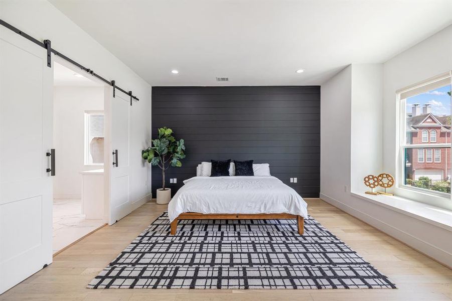 The primary bedroom is a luxurious retreat, featuring a spacious layout and elegant design elements that create a serene and inviting atmosphere. It offers ample room for relaxation and personal comfort, with stylish finishes and thoughtful details throughout.