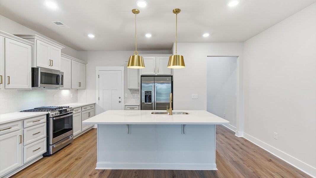 Accomplished kitchen design featuring pendant lighting above a statement island for both prep and gathering in Anderson, SC Accomplished kitchen design featuring pendant lighting above a statement island for both prep and gathering in Anderson, SC
