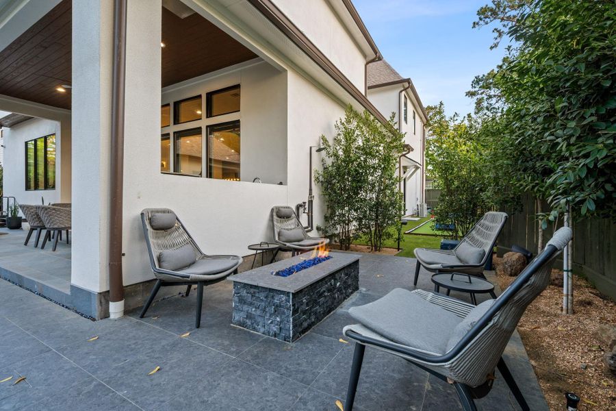 Intimate outdoor seating area centered around a modern fire feature—ideal for gathering and unwinding.