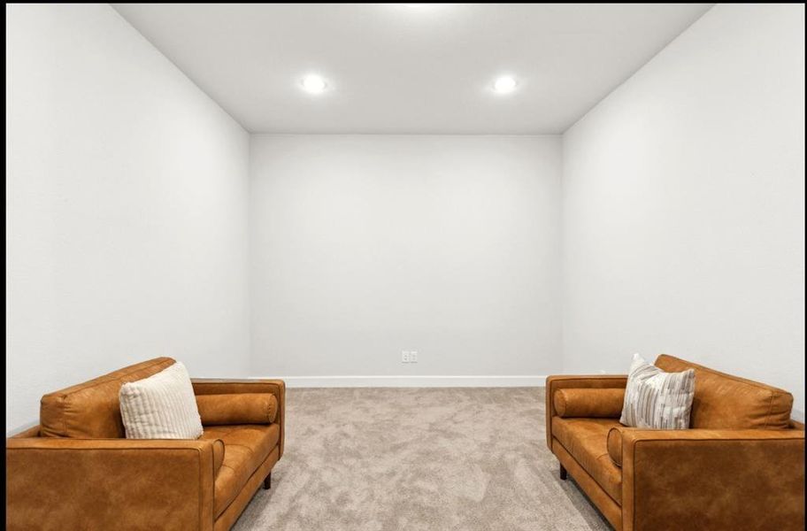 Living area with carpet flooring and recessed lighting