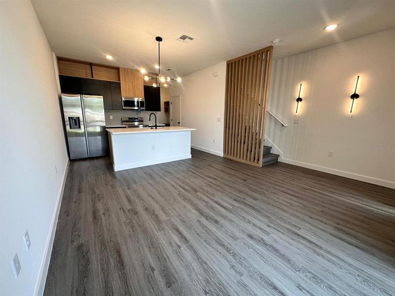 Upgraded cabinetry and lighting, quartz countertops, and wooden slats