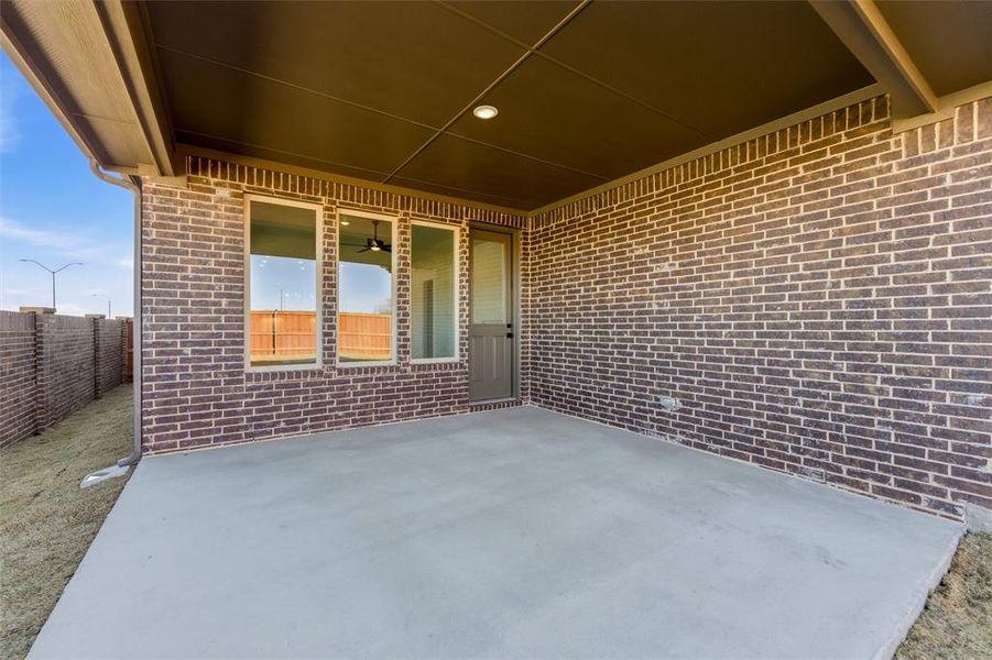 Fenced backyard with a patio area