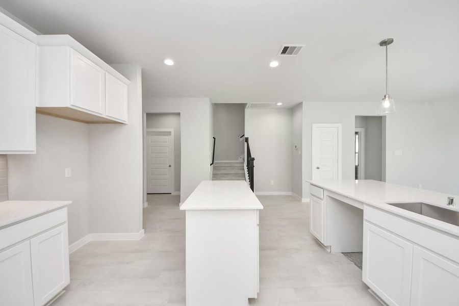 Culinary haven, featuring granite countertops, a tile backsplash, stainless steel appliances (to be installed), and 42” upper cabinets. Culinary haven, featuring granite countertops, a tile backsplash, stainless steel appliances (to be installed), and 42” upper cabinets.