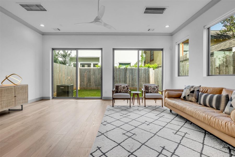 Enjoy a clear view of the backyard through the large glass sliding doors, creating a seamless connection between the indoor living space and the outdoors.