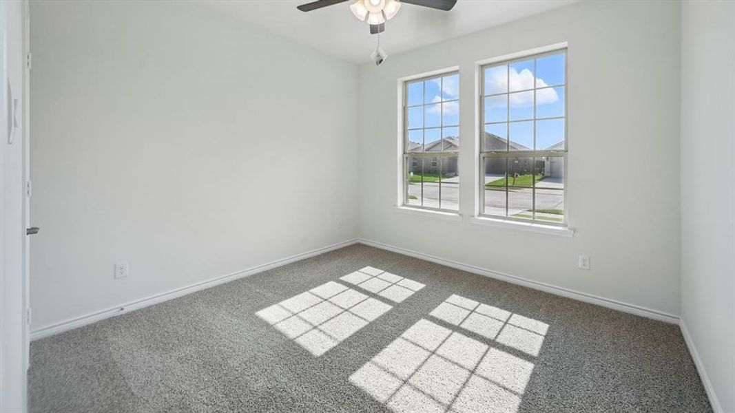Spare room with carpet flooring and a ceiling fan