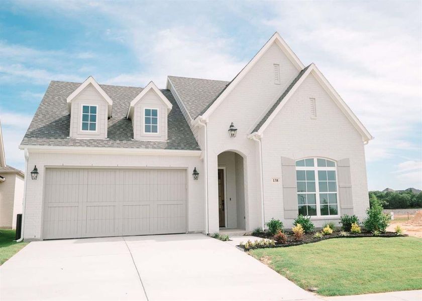 View of front facade with a front yard and a garage