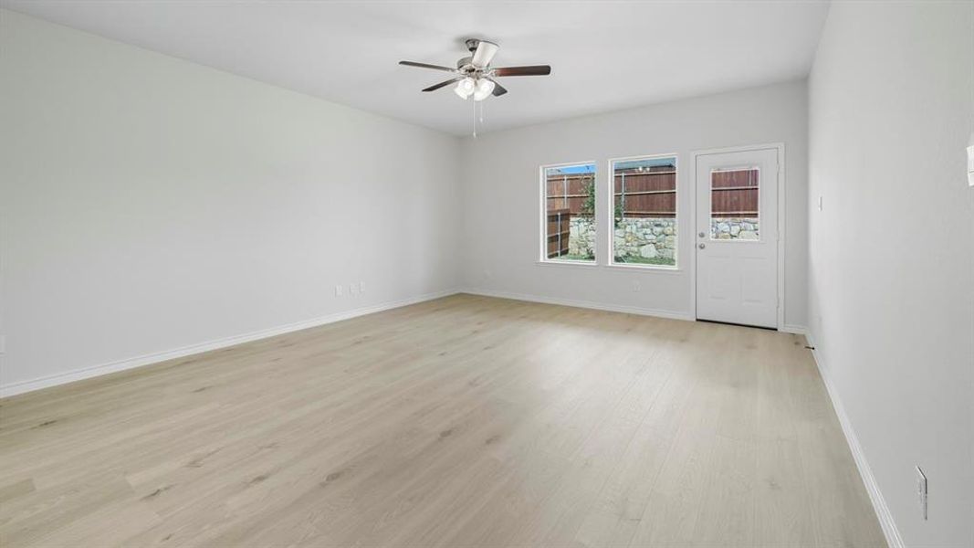 Unfurnished room featuring light wood finished floors and ceiling fan Unfurnished room featuring light wood finished floors and ceiling fan