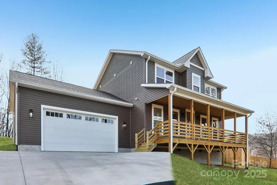 Front exterior of a new home in , Candler, NC, highlighting curb appeal (Image 1).
