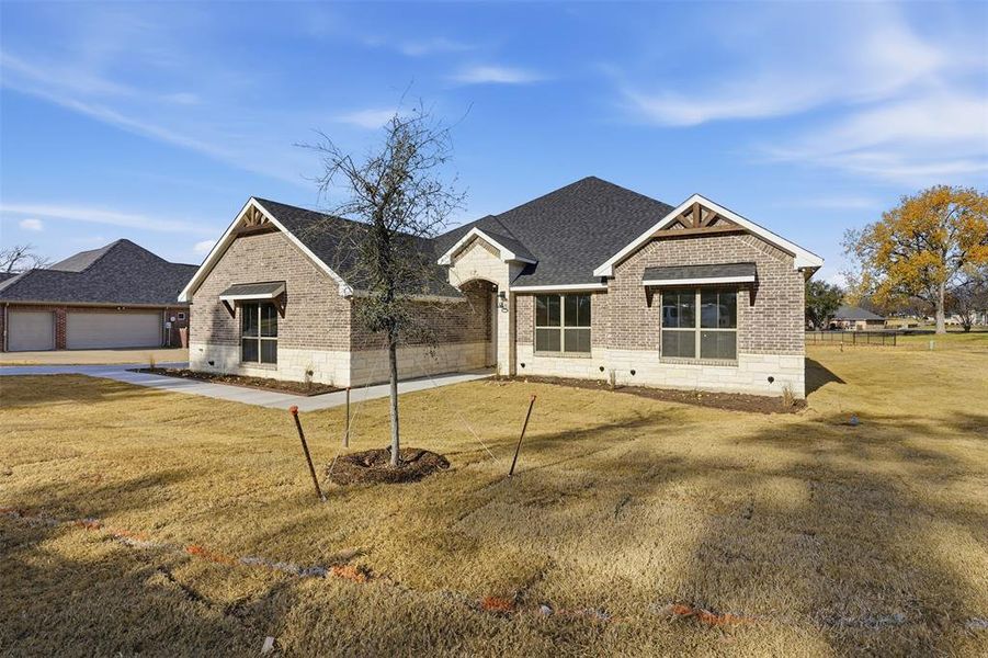 Front exterior of a new home in , Granbury, TX, highlighting curb appeal (Image 26).