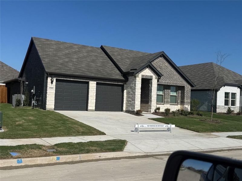 Modern home featuring a combination of light stone and dark brick exterior Modern home featuring a combination of light stone and dark brick exterior