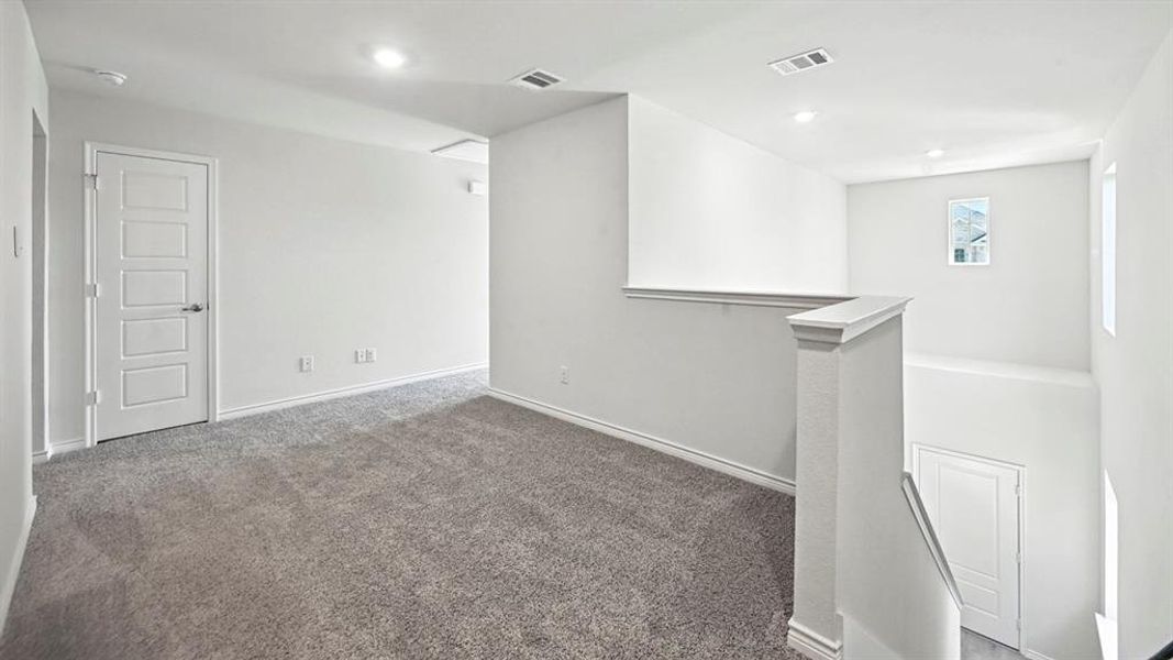 Carpeted empty room with baseboards and recessed lighting Carpeted empty room with baseboards and recessed lighting