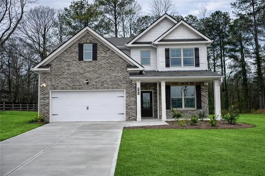 Front exterior of a new home in Paces Estates, Lithia Springs, GA, highlighting curb appeal (Image 1). Front exterior of a new home in Paces Estates, Lithia Springs, GA, highlighting curb appeal (Image 1).