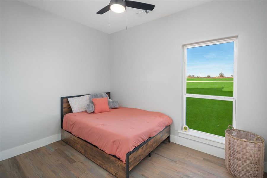 Bedroom with wood-type flooring and ceiling fan