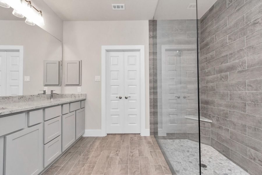 Enjoy an expansive walk-in shower with tile surround and modern finishes. Sample photo of completed home with similar floor plan. Actual colors and selections may vary. Enjoy an expansive walk-in shower with tile surround and modern finishes. Sample photo of completed home with similar floor plan. Actual colors and selections may vary.