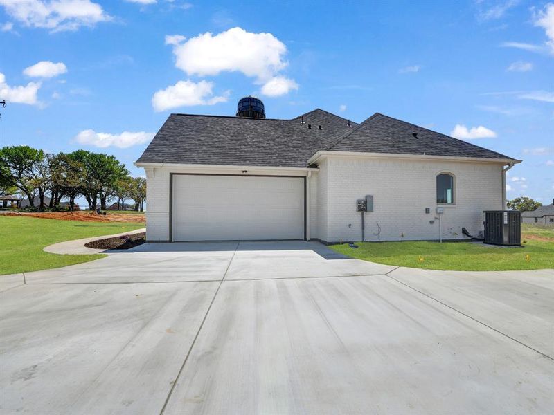View of home's exterior featuring central air condition unit, a lawn, a garage, and brick siding View of home's exterior featuring central air condition unit, a lawn, a garage, and brick siding