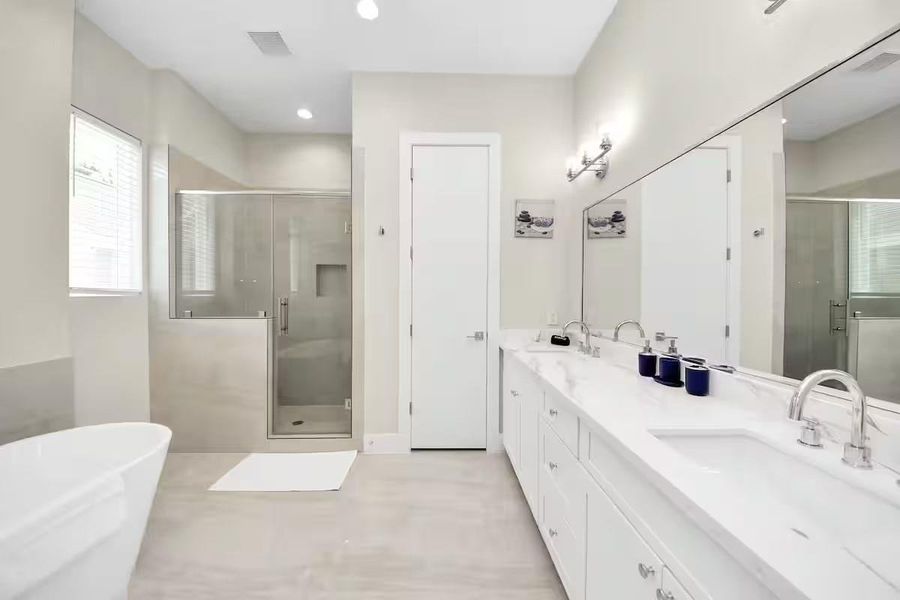 The primary bath gives you both options: a freestanding soaking tub when you want to unwind and a separate walk-in shower for the everyday routine.