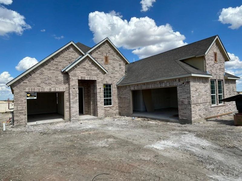 View of front of home featuring an attached garage, brick siding, roof with shingles, and driveway View of front of home featuring an attached garage, brick siding, roof with shingles, and driveway