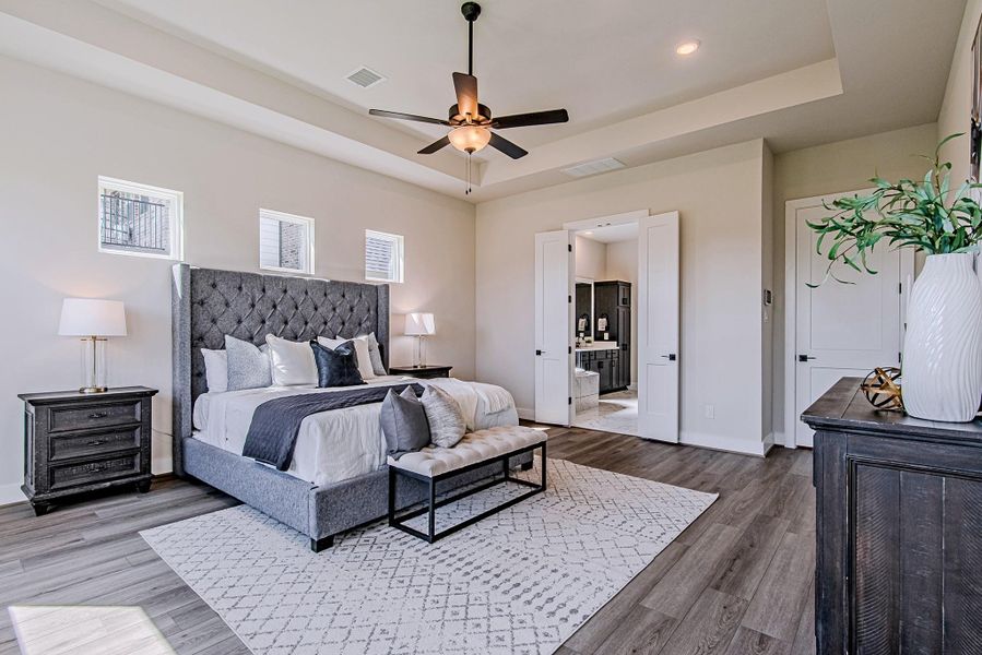 Another view of the primary suite showcasing its generous size and natural light