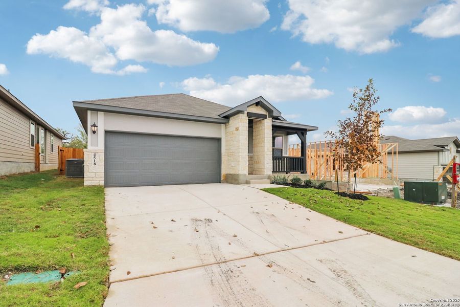 Front exterior of a new home in Remington Ranch, San Antonio, TX, highlighting curb appeal (Image 23). Front exterior of a new home in Remington Ranch, San Antonio, TX, highlighting curb appeal (Image 23).