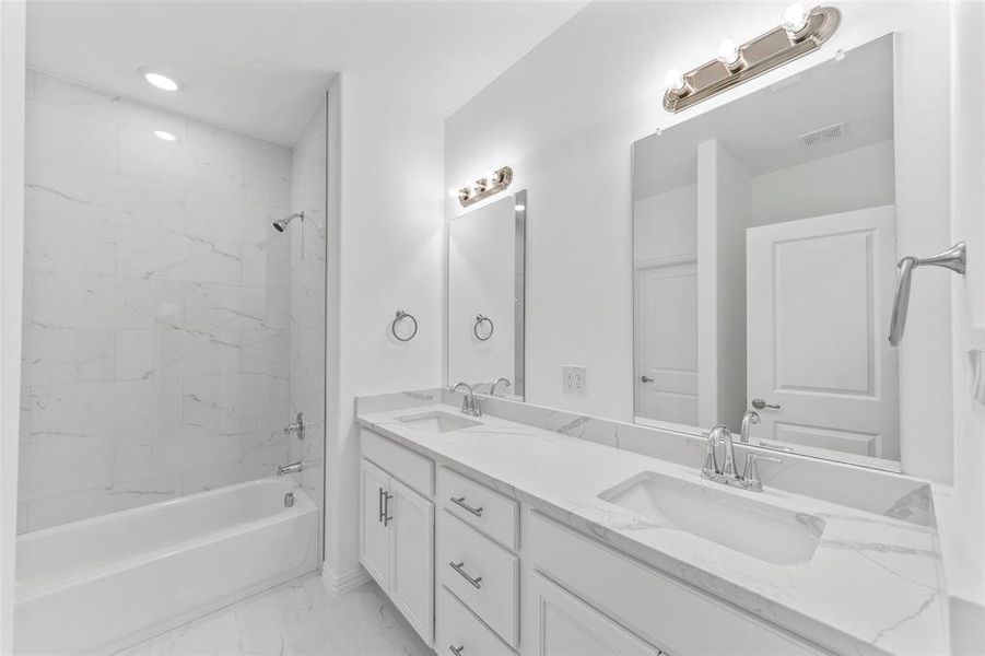 Primary Bathroom with dual vanities and shower / bath combo