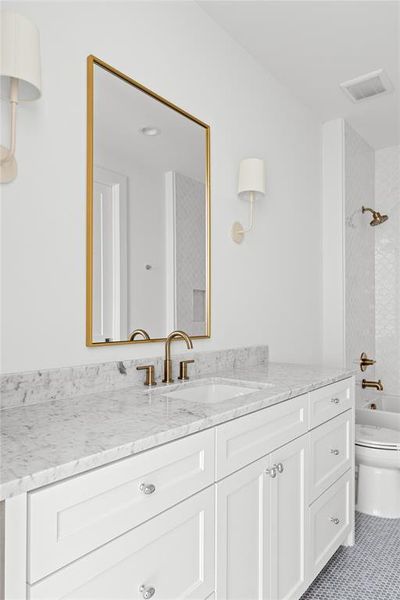 Bathroom featuring vanity and washtub / shower combination