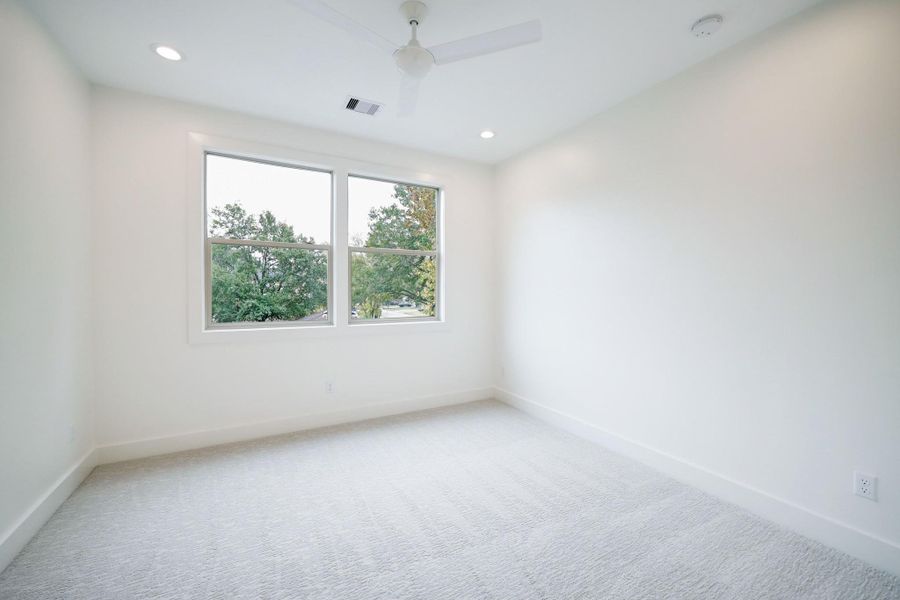 Secondary Bedroom #1 features a ceiling fan with recessed lighting, large closet space and shared bathroom. *Previous Project*