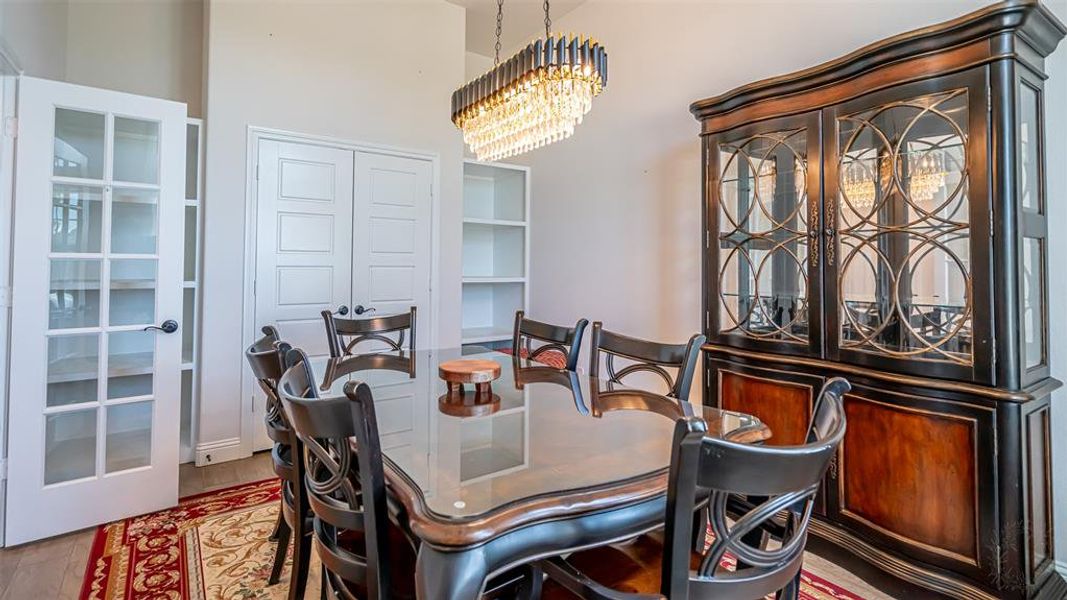 Formal dining area featuring a crystal chandelier and light wood-finish flooring